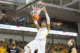 VCU basketball’s Justin Tillman throws down a jam. Recently, VCU became the first school to announce that it will comply with a recent court settlement and pay its players directly. 