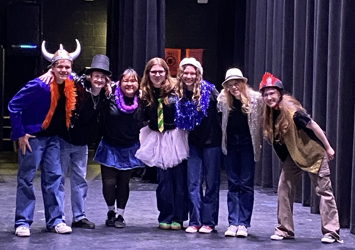 From left to right, Griffon Yetter, Andrew Friedman, Gillian Gutierrez, Eleanor Strader, Amanda Morris, Lyla McGowen and Marty Hester stand onstage before the talent show begins. The show happened on Saturday, February 15, 2025. Photo used with permission from Sophia Phaneuf. 