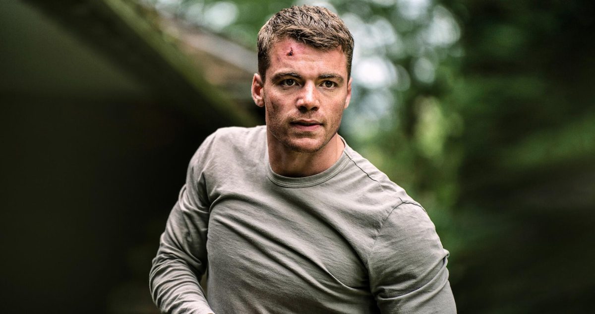 Agent Peter Sutherland (Gabriel Basso) battles in the woods after saving the President from multiple bombs. Peter plays a major role in saving important leaders in season one.  Photo courtesy of Netflix. 