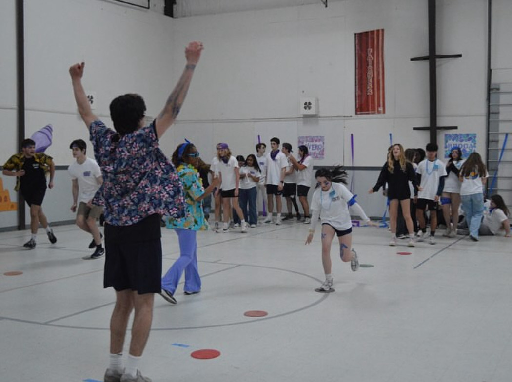 Senior and delegate counselor Kaden Pratt cheers on his Broca council as they compete against other councils in relay races at 4-H Wakefield, Va. Kaden was one of the six counselors who led and supported students in various activities throughout the weekend. Photo permission used from Kaden Pratt.