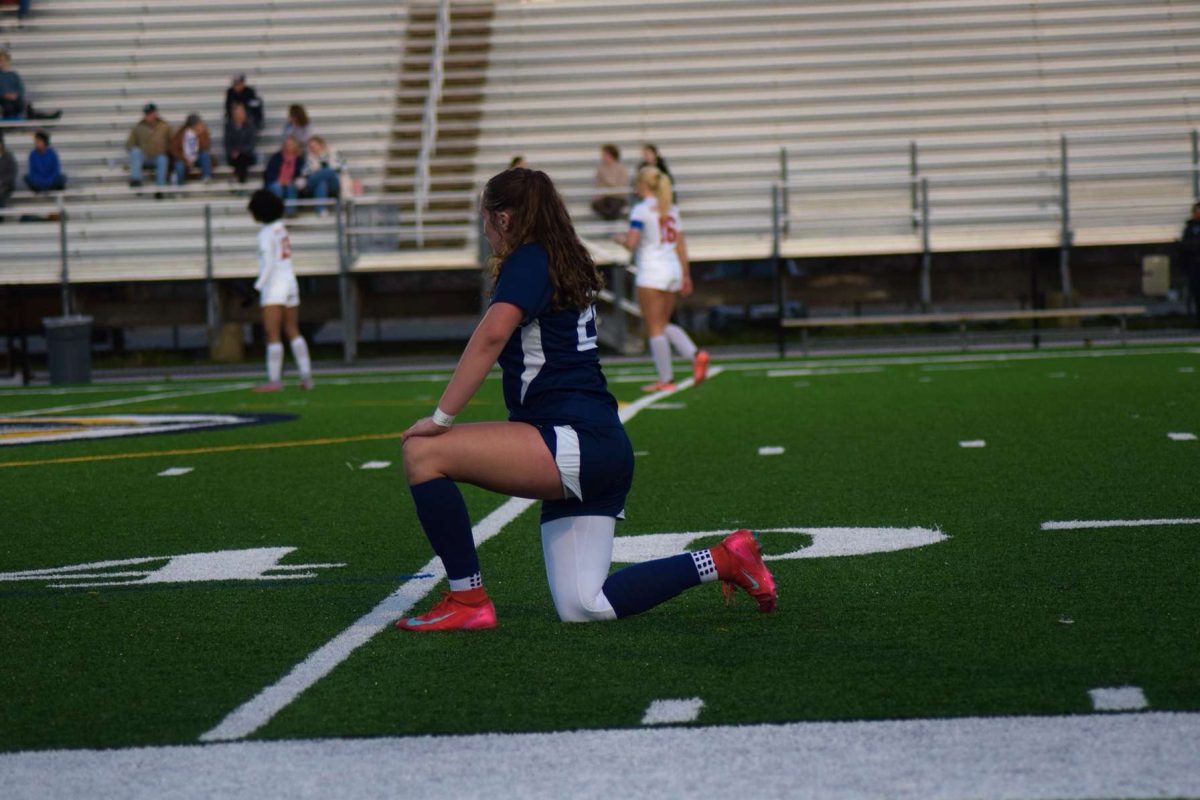 Forward Addison Duprey takes a quick cooldown during the game against Grassfield High on March 11, 2025. Cooldowns lower heart rates and can help reduce injury and promote muscle recovery.  Photo used with permission by Vivian Wolfe.