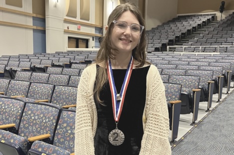 Sophomore Callie Harroun celebrates at the forensics super regional competition after winning second place. The competition was held on Saturday, March 1, 2025.