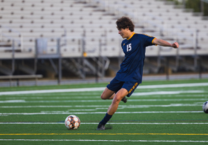 Senior Taden Domanski takes a free kick during a match on April 26, 2024 against First Colonial High School. Though they would go on to lose this particular match, Domanski and other returners are keen on achieving different results this season. Photo used with permission by Zak Kain-Kuzniewski.