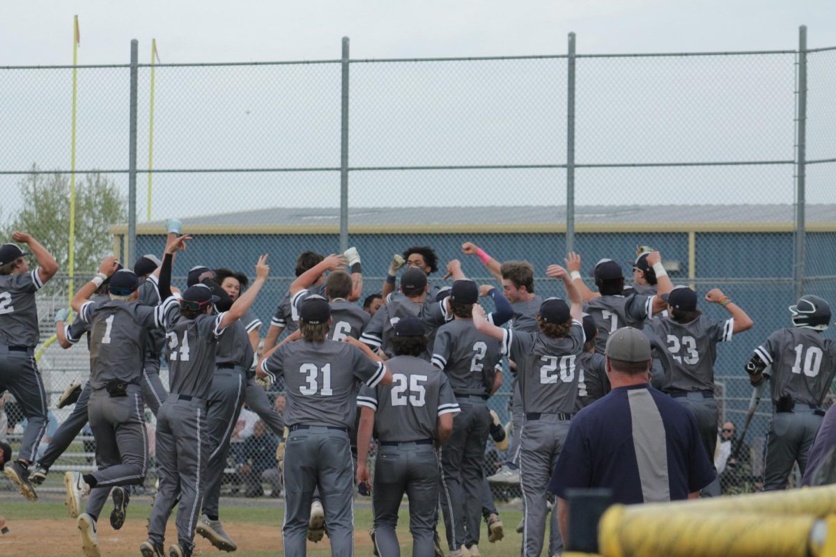 Junior Tre Hamilton celebrates with his team after a three-run home run to left field at Ocean Lakes High School on April 24, 2025. The Dolphins were in the lead 5-0 at the end of the fifth inning.