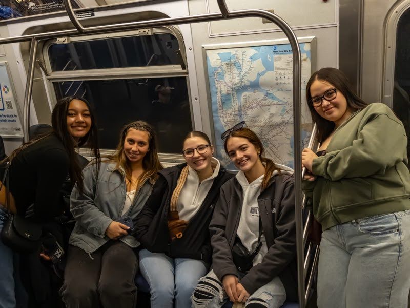 Sophomore Kennedy Walls, seniors Rania Jacobs, Veronica Watkins, Kairi Heinrichs and junior Larissa Almendras enjoy a ride on the E-train in Brooklyn, New York, on April 10, 2025. They enjoyed a dinner cruise on the Hudson River shortly after. 