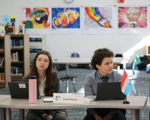Caption: Amelia Montgomery and Cassi Terry represent Luxembourg at the event. The debate is a lesson in negotiation and collaboration for its participants. Photo used with permission by J Picou-620 Design. 
