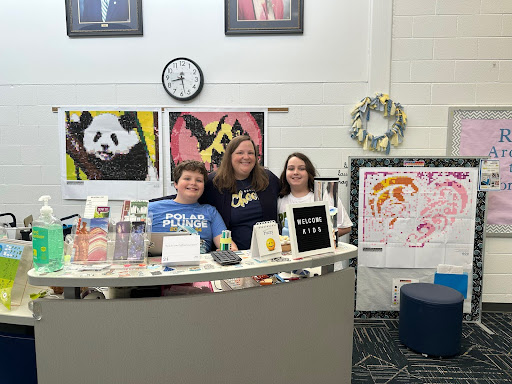 Library specialist Emily Kilmartin puts her kids, Emmet and Connor, to work on Take Our Daughters and Sons to Work Day. Photo taken on Thursday, April 24, 2025 in the Ocean Lakes library.