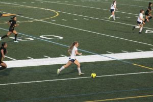 Junior Anna Wiggins dribbles the ball down the field on April 25, 2025, at Floyd E. Kellam High School. Anna has been a key player for the team this year.