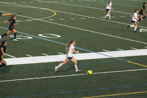 Junior Anna Wiggins dribbles the ball down the field on April 25, 2025, at Floyd E. Kellam High School. Anna has been a key player for the team this year.