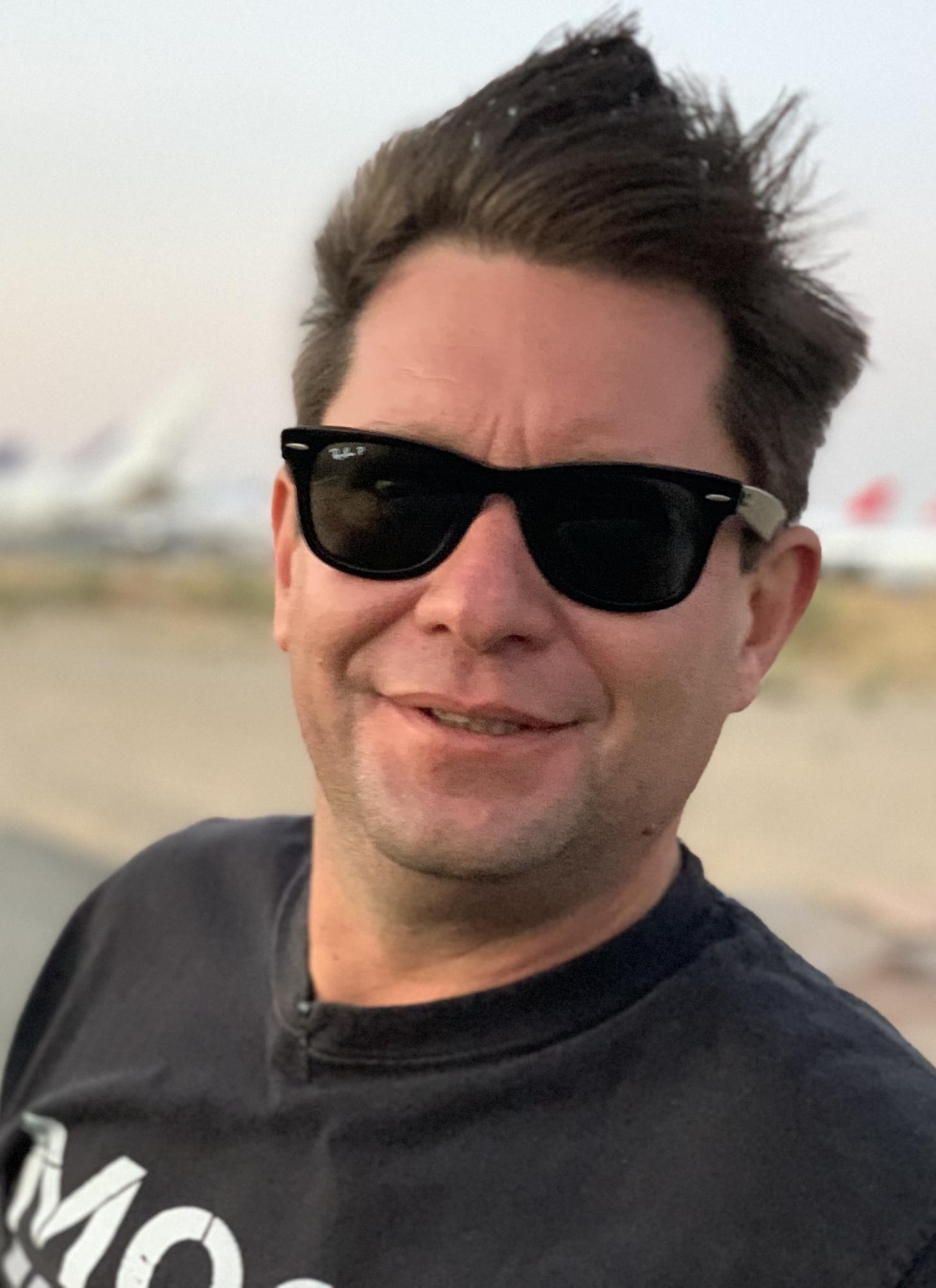 Ashlee Vance smiles at the camera while visiting the Mojave Air and Space Port on Sept. 25, 2020. His detailed books, articles and videos often require him to travel globally. Photo used with permission from Ashlee Vance.