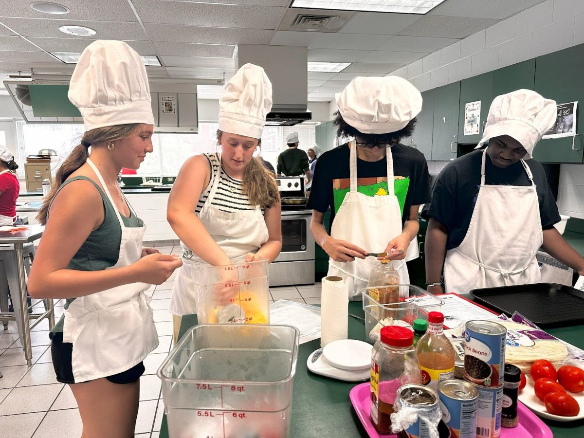 From left to right: Freshman Camryn Early and Sophomores Addyson Duprey, Cameron Torres, and Junior Rayshard Branch work on one of their last cooking labs for Ms. Holuka’s Culinary class. 