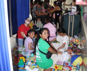 Junior Haymi Patel sits in the postoperative unit as she plays with the children. Haymi found that bonding with the children also bonded her to those she knew. “There are certain patients that you definitely bond with more and bonding with those patients together [left us a lasting impression],” Haymi said. Photo used with permission by Haymi Patel.