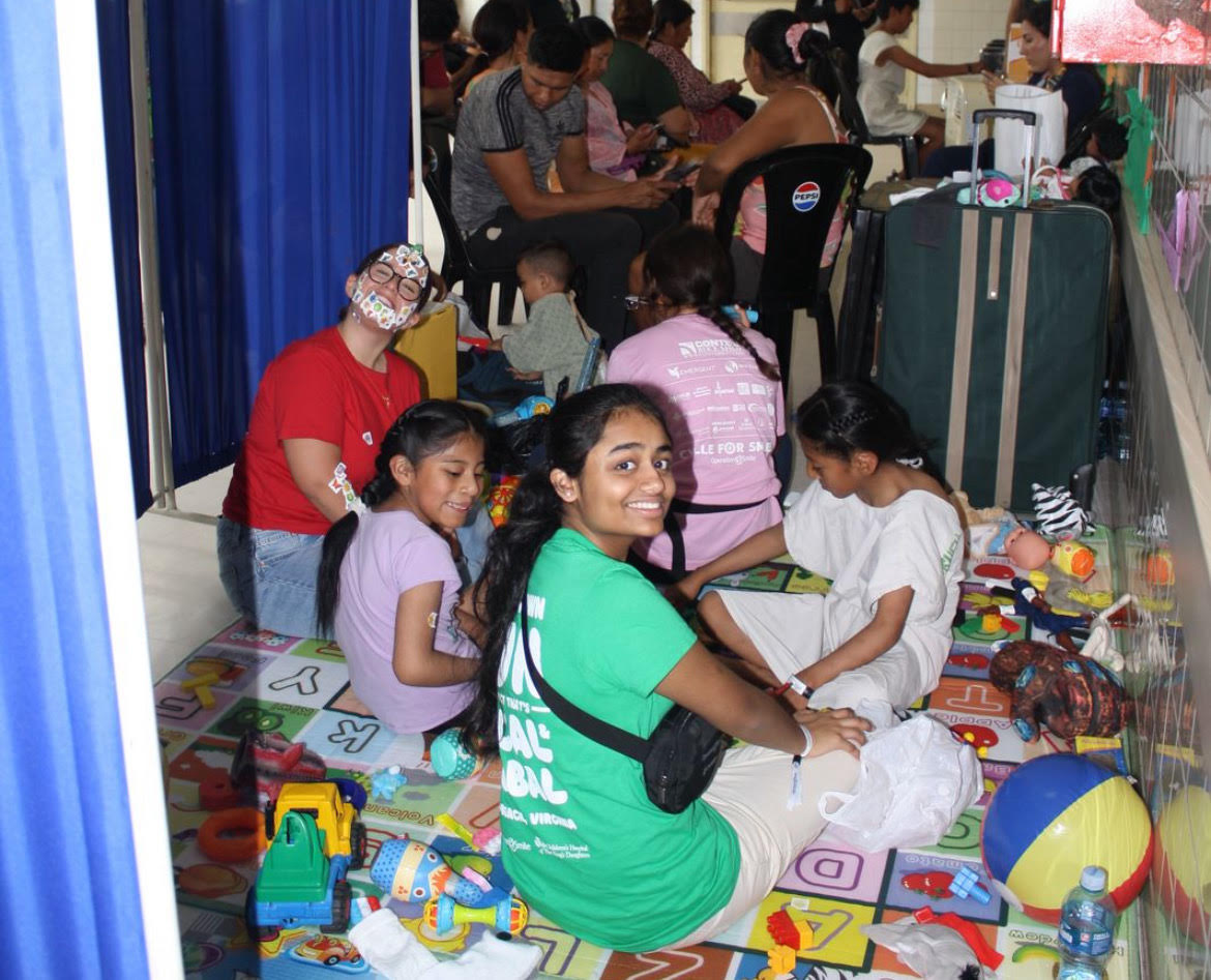 Junior Haymi Patel sits in the postoperative unit as she plays with the children. Haymi found that bonding with the children also bonded her to those she knew. “There are certain patients that you definitely bond with more and bonding with those patients together [left us a lasting impression],” Haymi said. Photo used with permission by Haymi Patel.