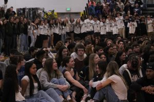 During the Spring Assembly on March 28, 2025, Ocean Lakes High school seniors sit on the ground while sports teams surround them with their hands wrapped around each other. PE teacher Yolanda Boothe gives a speech about how high school is fleeting, telling each student and teacher to cherish the time they have in this community.
