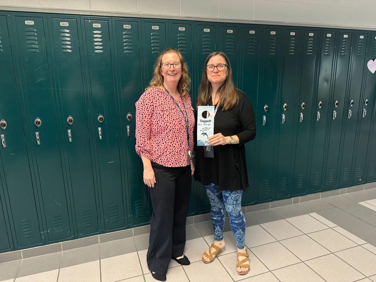 From left to right: Tara Yurik and Elizabeth Boys hold newly received “tagged” awards, taken on March 11, 2025 in the math hallway.