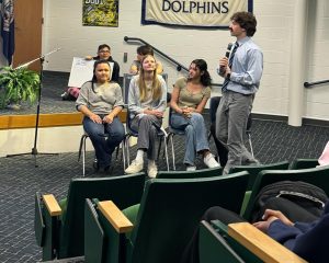 From behind: juniors Henry Nguyen and Josh Ng kept track of points for the competition. The competitors for the senior class from left to right are Gillian Gutierrez, Lauren Bulleigh, Grace Melendez and Nina Elizondo. Senior Thomas Dillard role-played as Steve Harvey. Picture was taken on April 24, 2025.