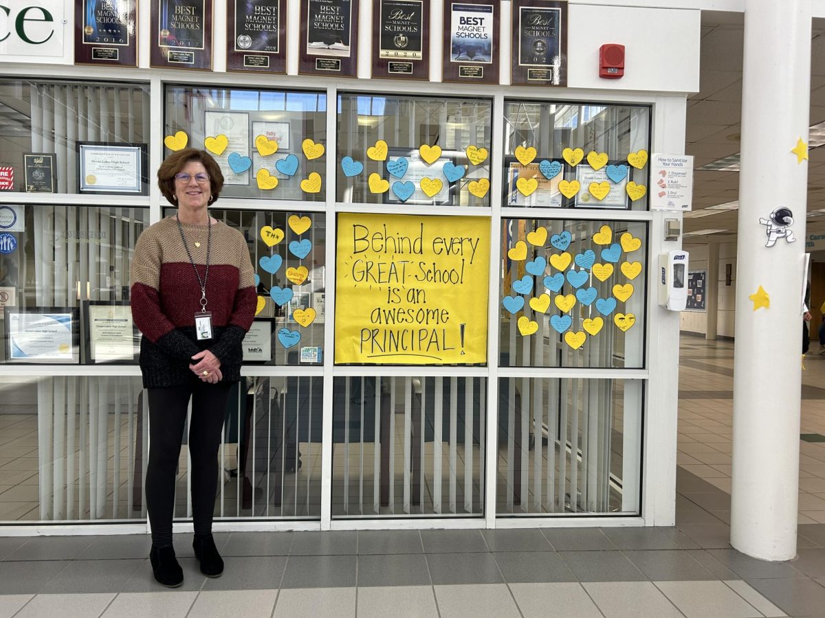 Dr. Claire LeBlanc stands with a sign surrounded by affectionate notes from students. The sign and notes were a part of principal appreciation week. 