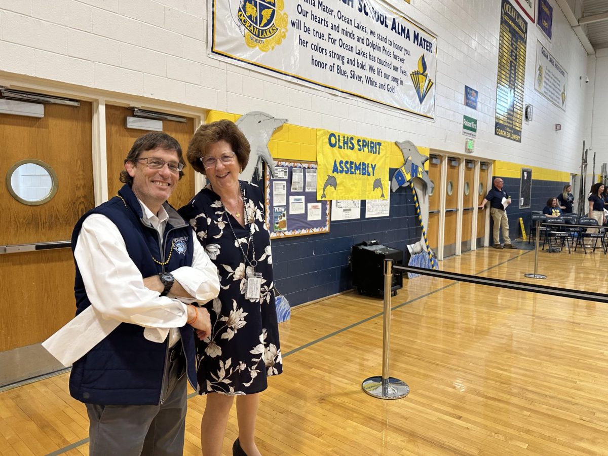 Dr. Claire LeBlanc poses for a photo with her number one fan, assistant principal James Imbriale. This photo was taken before her last-ever all-school assembly as principal of Ocean Lakes High School.