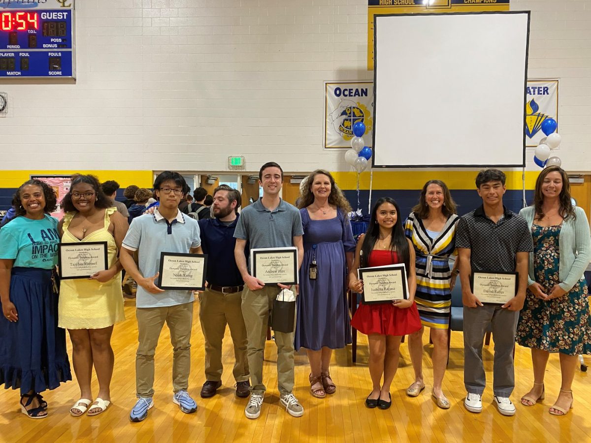Pictured from left to right: Yvaal Hampton, Tajyhia Manuel, Noah Xiong, Mike Mosley, Andrew Herr, Amy Jo Harrell, Isabella Ragasa, Andrea Smolin, David Suiter, Amber Moore. Five of the six Dynamic Dolphins stand next to their presenter on June 6, 2025. Eleanor Strader was not present to receive her award. Photo used with permission from Allison Graves.