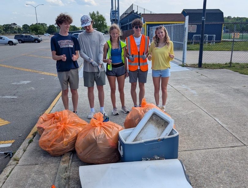 Pictured from left to right: Seniors Bryce Phillips, Miles Gravitt, Lindsay Meadows, Roman Chapman and Grace Thompson examined the pile of trash they collected around Ocean Lakes and the Virginia Beach Little League. The students received an award for “most pounds of trash removed” after the clean up. The photo was taken on April 30, 2025, in the Ocean Lakes High School student parking lot. 
