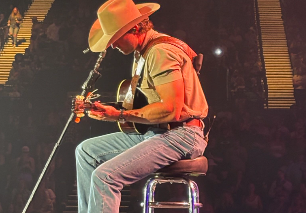 Popular country artist Riley Green performs Worst Way on acoustic guitar at Patriotic Festival on May 24, 2025. The audience sings along in unison as he strums and illuminates the stage. Photo used with permission, taken by Lily Lipsky.