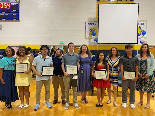 Pictured from left to right: Yvaal Hampton, Tajyhia Manuel, Noah Xiong, Mike Mosley, Andrew Herr, Amy Jo Harrel, Isabella Ragasa, Andrea Smolin, David Suiter, Amber Moore. Five of the six Dynamic Dolphins stand next to their presenter on June 6, 2025. Eleanor Strader was not present to receive her award.  Photo used with permission from Allison Graves.

