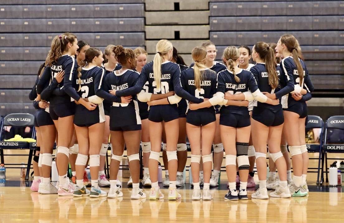 The team huddles up during a timeout in a game against Kellam High School at Ocean Lakes High School on Sept. 10, 2024, later winning the game 3-0. Photo used with permission from Carmela Mendoza.