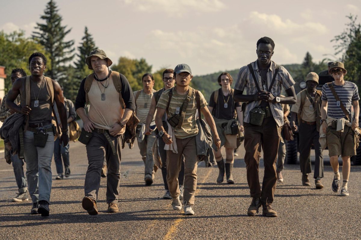 Pictured from left to right: Peter McVries (David Jonsson), Raymond Garraty (Cooper Hoffman), Hank Olsen (Ben Wang), and Arthur Baker (Tut Nyuot) begin “The Long Walk”. A 50-person survival game where the person that walks the longest wins. Courtesy of IMDb.