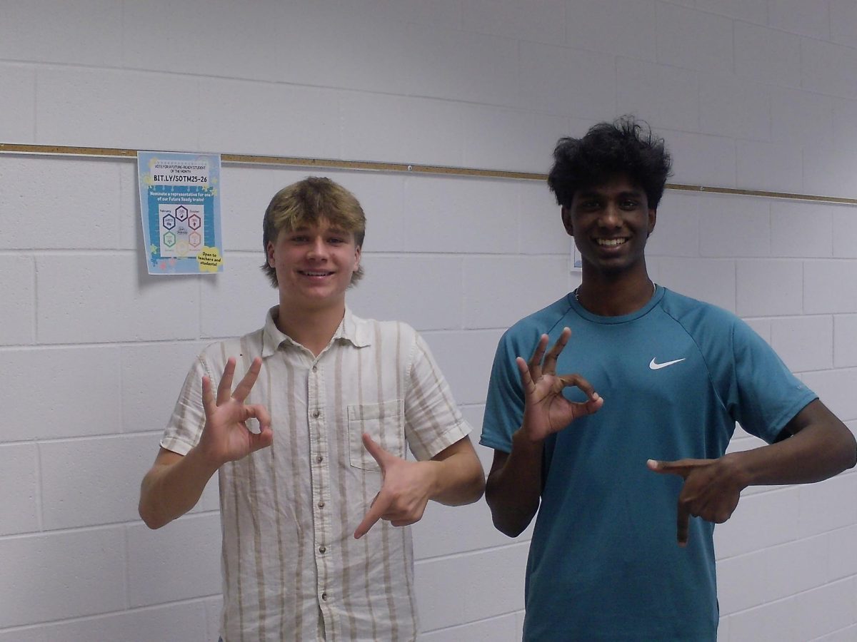 From left to right: Issac Richardson and Nathen Varghesse, who are both sophmores at Ocean Lakes High School. Taken in the language hallway on Oct. 9, 2025 with two alumni posing with the "6 7" sign.