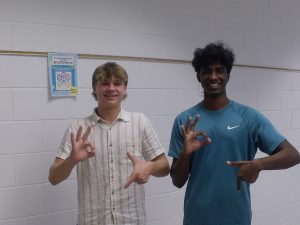 From left to right: Sophomores Issac Richardson and Nathen Varghese pose with the "6 7" sign in the language hallway on Oct. 9, 2025, at Ocean Lakes High School.