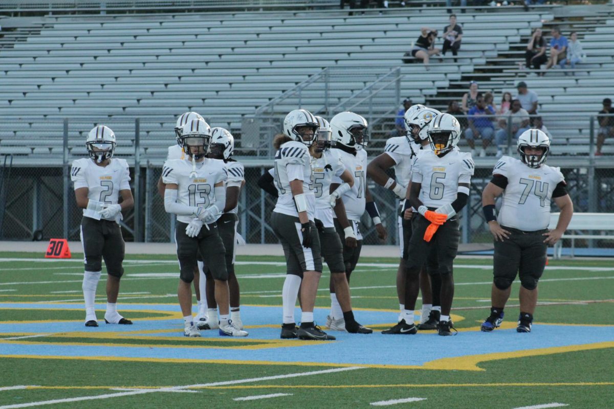 Ocean Lakes Varsity Football looks at the sideline for the offensive play at First Colonial High School on Sept. 5, 2025. The Dolphins had an ending score of 43-0 against the Patriots.
