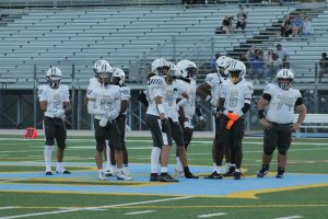 Ocean Lakes Varsity Football looks at the sideline for the offensive play at First Colonial High School on Sept. 5, 2025. The Dolphins had an ending score of 43-0 against the Patriots.
