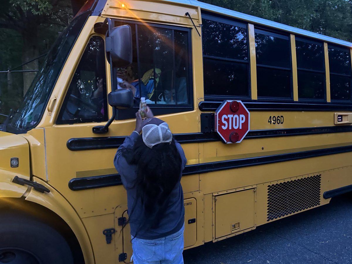 VBCPS bus driver receives a Chik-fil A gift bag from Ocean Lakes High School’s PTSA for bus driver appreciation week. The bus drivers keep students safe, to and from school, with the help of the AI-powered stop-arm cameras. Photo taken by Fara Wiles on Oct. 24, 2025.