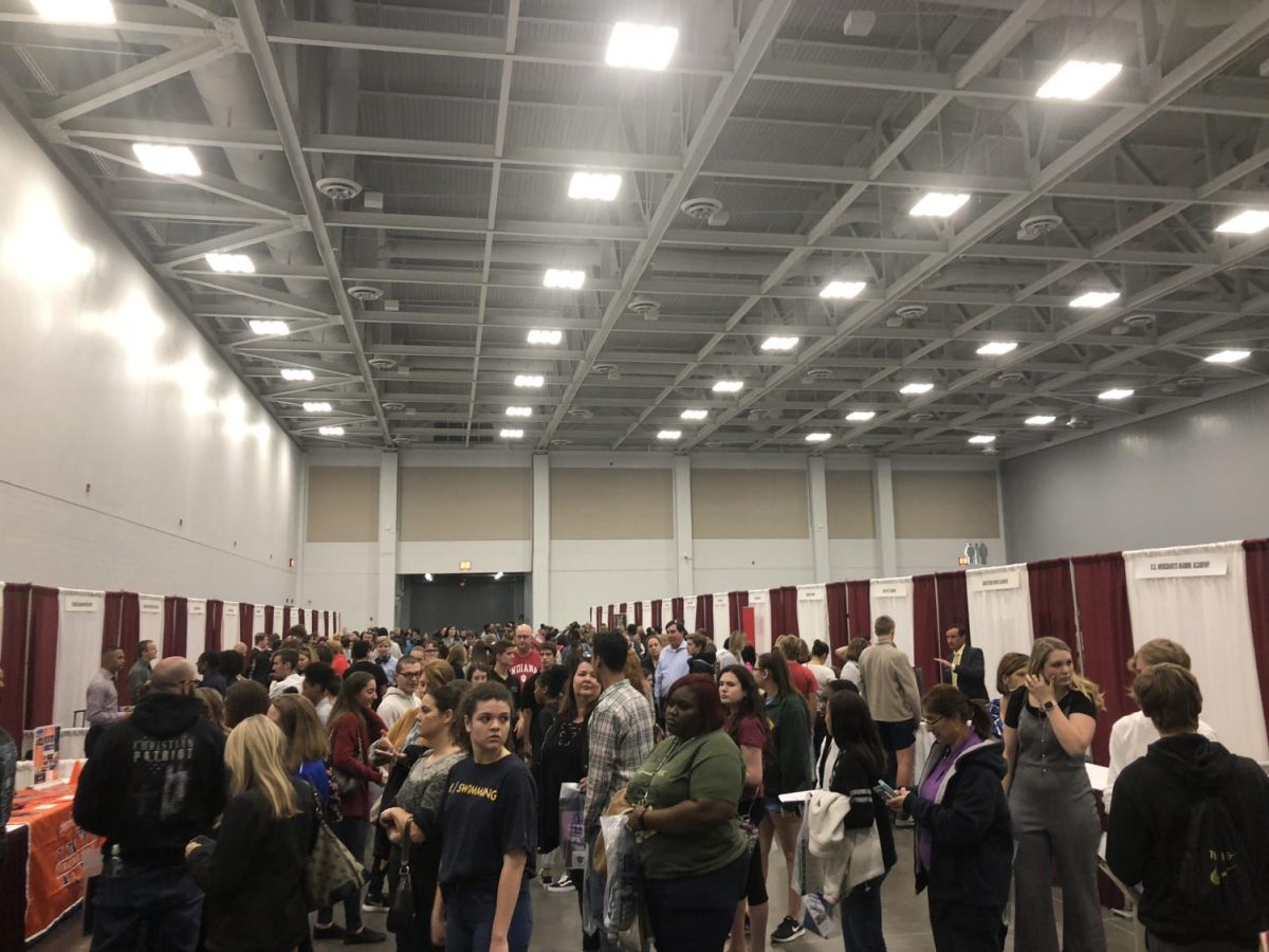 Attendees and their families look at different booths during College Night in the Virginia Beach Convention Center in 2018.