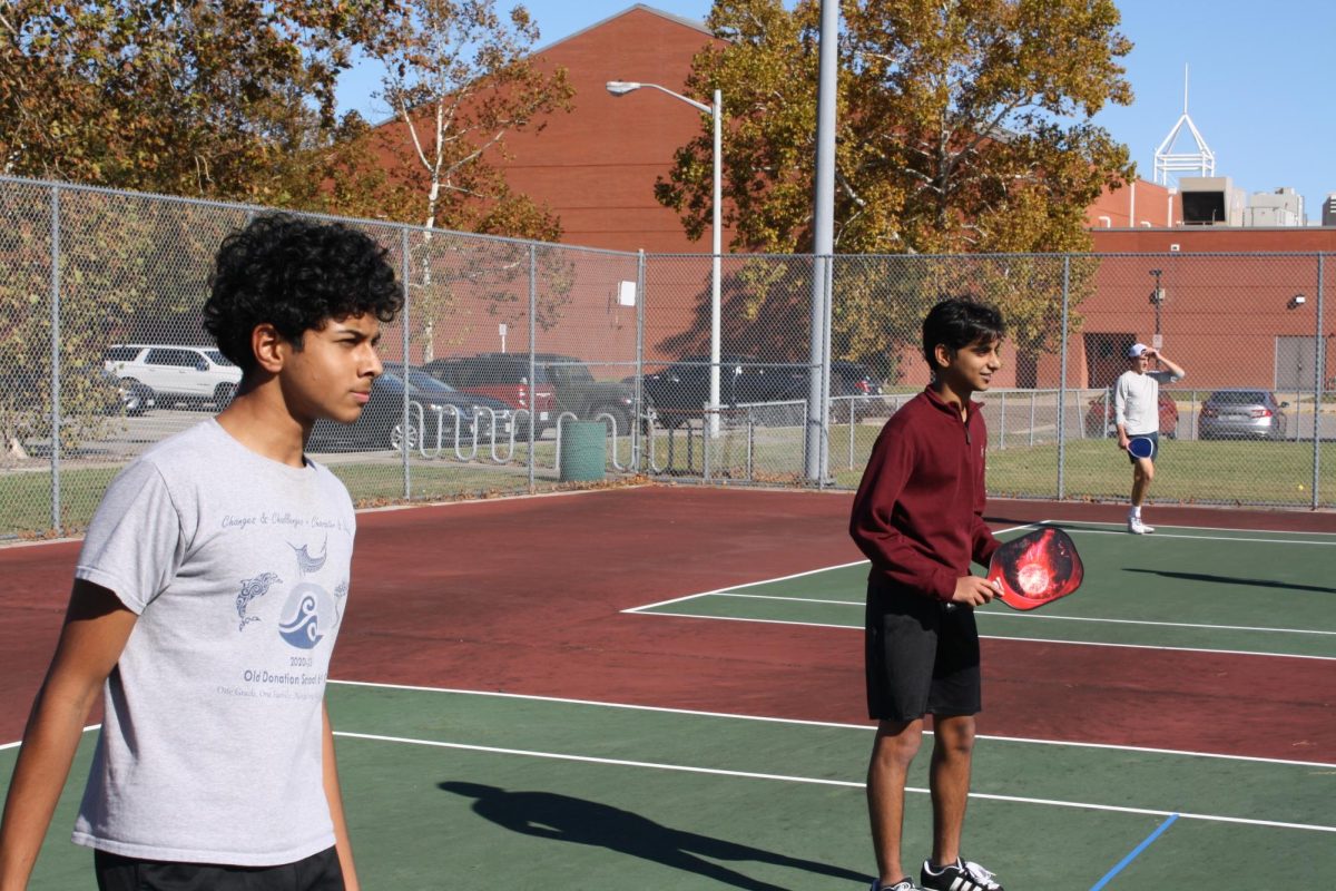 Pictured from left to right: Juniors Shrihan Mishra and Salman Hasan await a serve by the opposing team at the OL Pickleball Club’s meeting on Oct. 23, 2025. It was the club’s first meeting of the year.