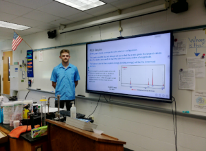 Stopper stands in the front of his classroom, room 221, after teaching his class about photoelectron spectroscopy. Photoelectron spectroscopy is a method that investigates the properties of elements through light. The photo was taken on September 12. 2025.