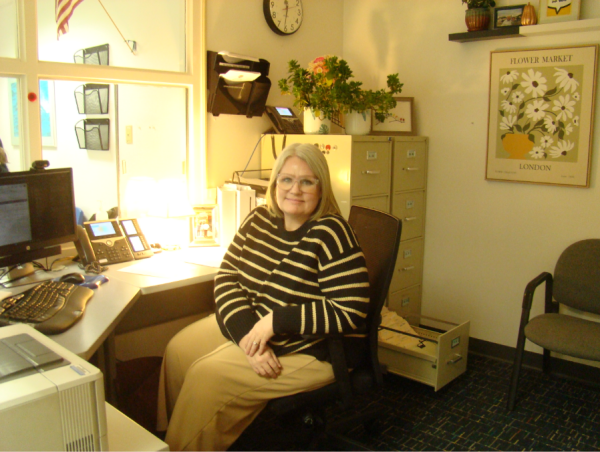 Attendance secretary Elizabeth Cooper works with students from 7 a.m. to 2 p.m. each day, helping them sign in and out of school. Pictured here on Sept. 18, 2025, Cooper takes a quick break to smile for the camera. 