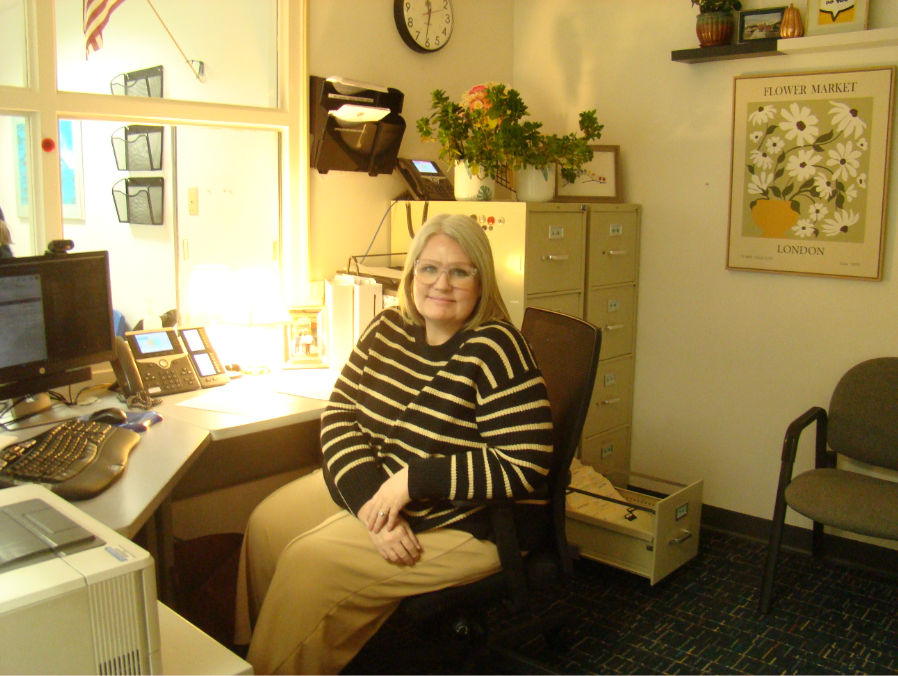 Attendance secretary Elizabeth Cooper is pictured after taking care of students throughout the day on Sept. 18, 2025. Cooper has just finished helping a student sign out of school, making conversation with her signature smile. 