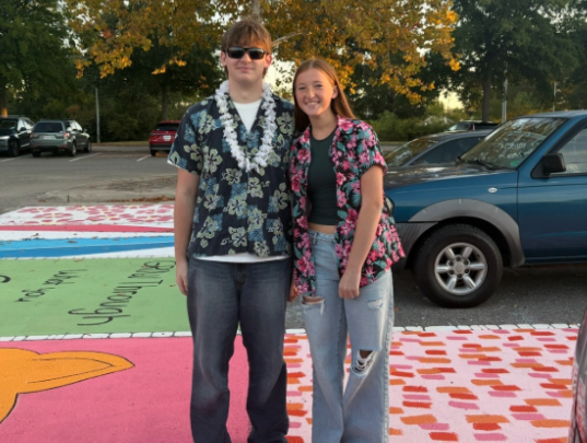 Senior Colt Walker and freshman Paisley Walker stand together in the student parking lot on September 4. The Spirit day was Surf vs Turf and students were expected to dress in beach or country clothing. Photo taken by Erin Broderick.