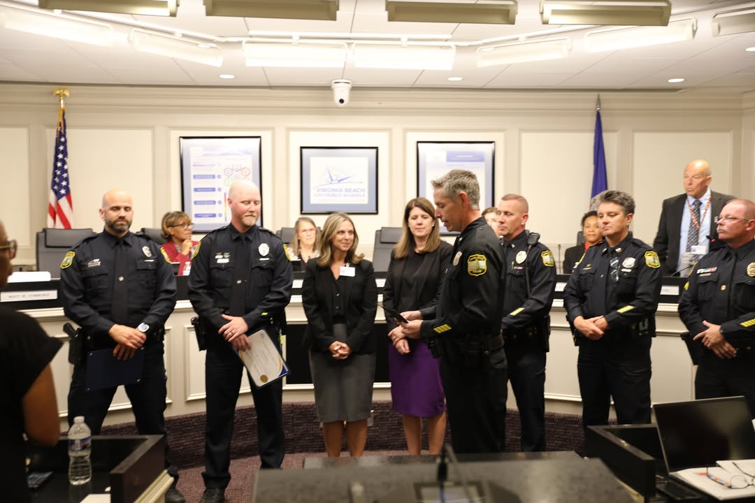 Officers Christopher Crescenzi and Cameron Kolmer receiving their Life Saving Award from their deputy chief in front of the Virginia Beach School Board on Sep. 23, 2025. Kolmer claims that receiving the award was unexpected. Image courtesy of Virginia Beach City Public Schools.