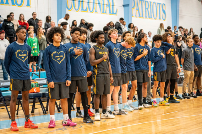 Ocean Lakes boys’ basketball stands for the National Anthem at First Colonial High School on Dec. 5, 2025 against the Patriots. The Dolphins would go on to narrowly lose to the Patriots 50-43 in this contest. Photo courtesy of Mason Gramkowski. 