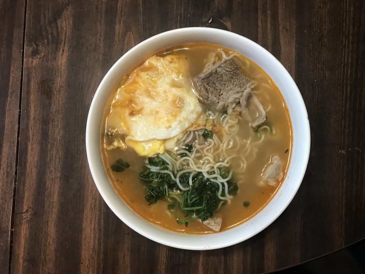 A bowl of instant noodles. It demonstrates exactly what one can do to make it healthier, such as adding an egg. 