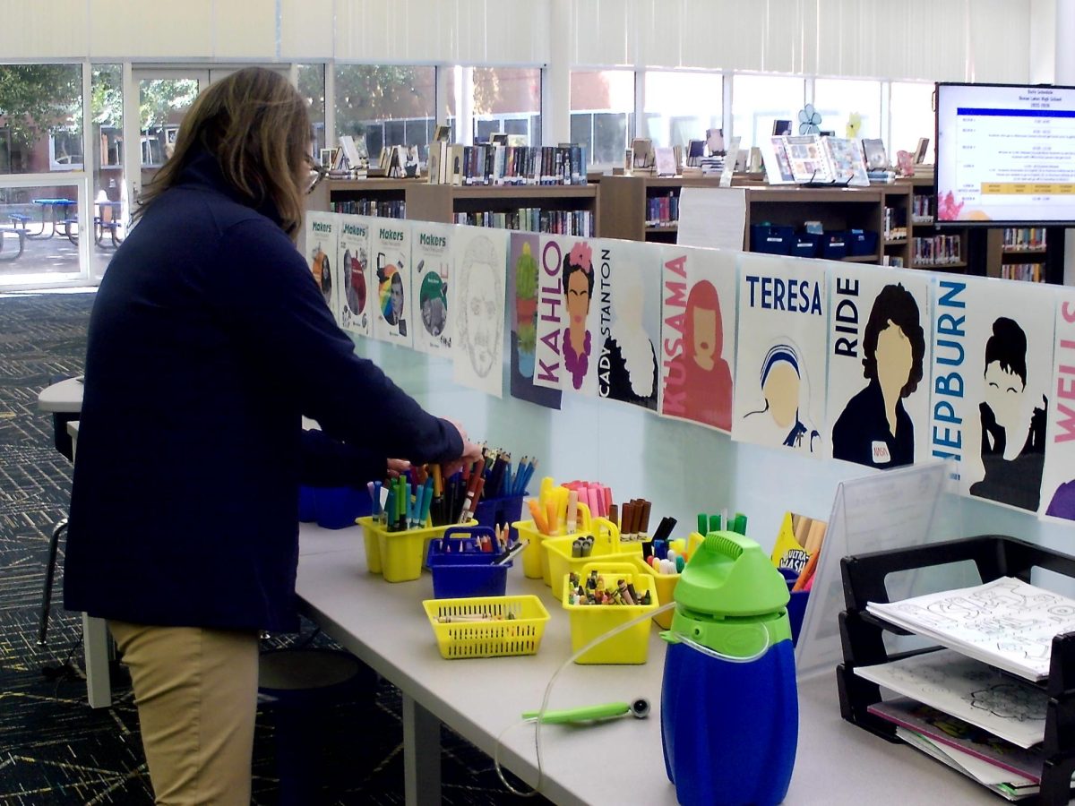 Nicole Glaser reorganizing and setting up a coloring station at Ocean Lakes High School’s library on March 17, 2026. This is one of the many resources that students can use at the school library, and is constantly maintained by staff.