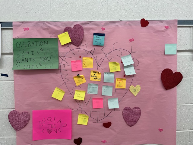 Operation Smile members gathered at their Feb. 11 “Spread the Love” meeting to fill a collaborative poster. The poster contains sticky notes with the joys in students' lives that make them smile. 
