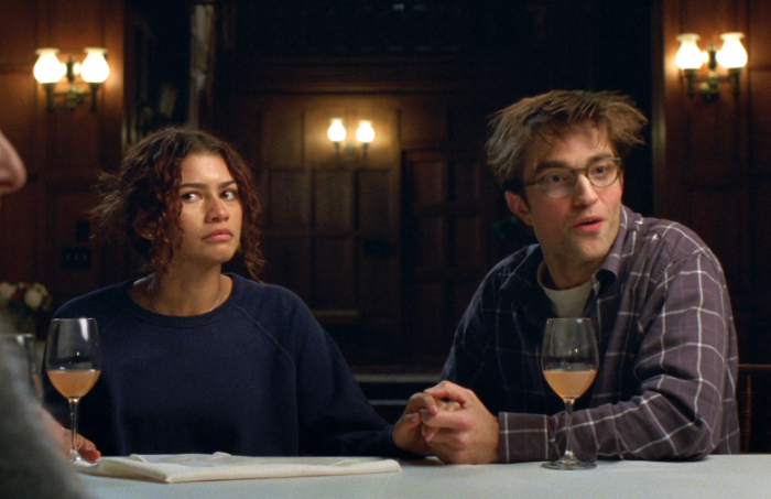 Emma (Zendaya) and Charlie (Robert Pattinson) sit at a wine tasting while talking to the best man and maid of honor. It is during this dinner that the confession that powers the movie is given. Courtesy of: A24.
