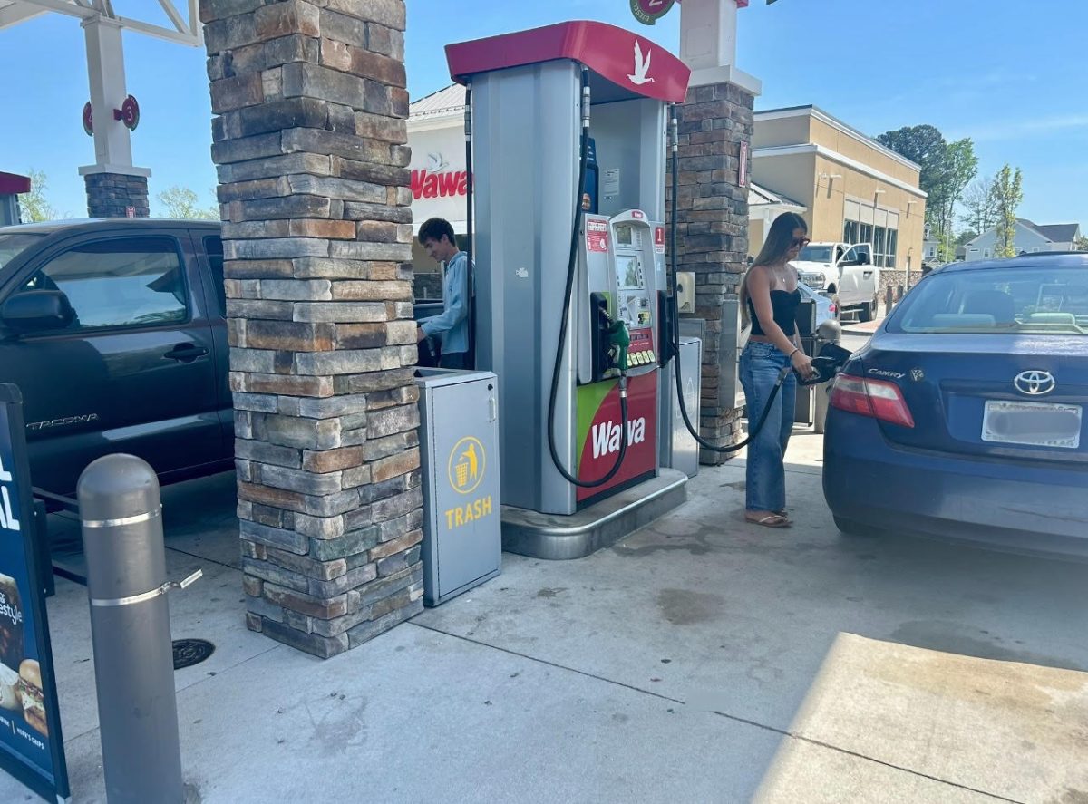Seniors Dillon Libasci and Kelsey Cruz pump gas at Wawa before driving home on April 15. As of April 16, the cost is about 50 cents higher compared to last month.