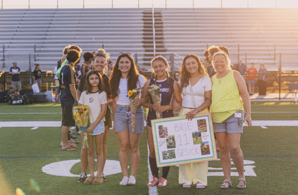 Senior Brie Gesick celebrates senior night with her friends and family members on May 19. Despite suffering from numerous injuries throughout her time at Ocean Lakes, Brie has preserved and become a starting defender for the Lady Dolphins. Photo courtesy of David Suiter. 