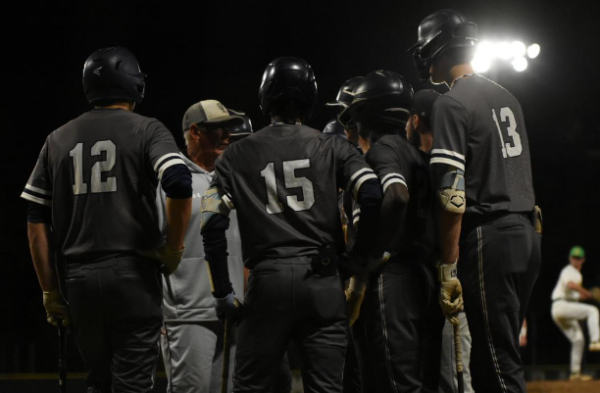 From left, sophomore Dominic Dimicelli, junior Seinko Augins, junior George Casher, and sophomore Liam Chown huddle around Coach Pete Zell during warm ups prior to their Hanahan Invitational Tournament game against Summerville on April 7, 2026. Ocean lakes won 12-0. 