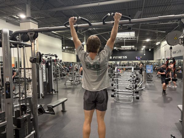 Senior Ryland King prepares to perform a pull-up in OneLife Fitness on June 1. Pull-ups are one of the components that make up the Presidential Fitness Test.