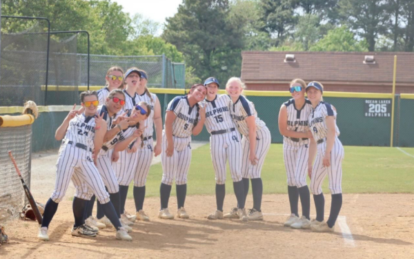 Varsity softball poses for a picture during a game at Ocean Lakes. Softball stood as the one seed before the regional tournament at the end of the regular season. Photo used with permission of Addison Munson.